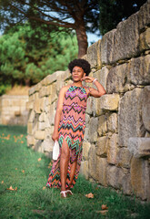 spring walks. spring mood. green park. spring portrait of a girl. girl walking in the spring park near the stone wall