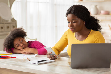 Busy Black Mother Working From Home, Ignoring Her Bored Little Daughter