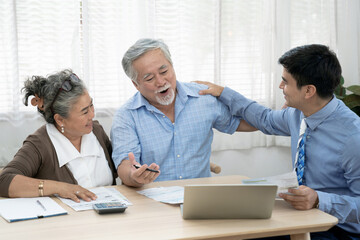 An insurance agent offers health insurance for Asian elderly couples, Finance staff present and...