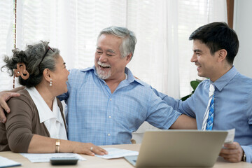 An insurance agent offers health insurance for Asian elderly couples, Finance staff present and close real estate sales.