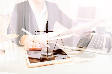 Justice and law concept.Male judge in a courtroom with the gavel, working with, computer and...