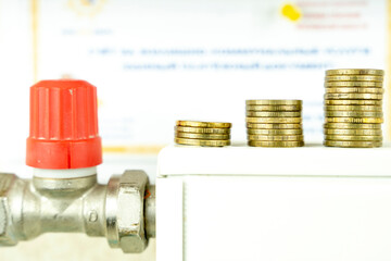 coins on the radiator, the concept of increasing utility bills
