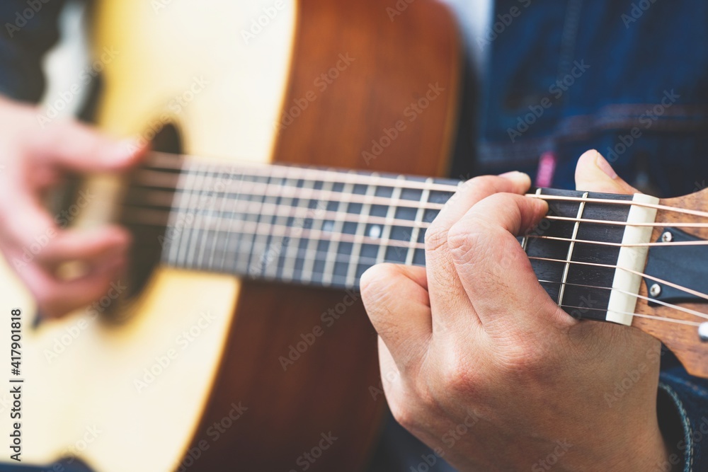 Wall mural Guitar playing. musician playing guitar Closeup Photography.	