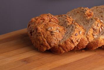 Loaf of bread, cut into slices, lies on a cutting board