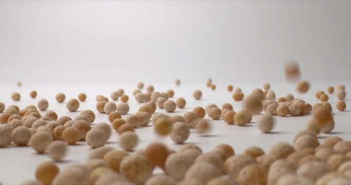 Falling chickpea beans on a white surface. Health concept. High protein Foods to eat. Close up. High quality. 4k footage.