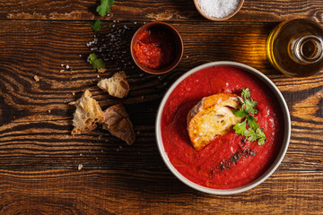 Bowl of tomato soup with toasted bread directly above