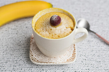 muffin in a mug with banana flavor. Muffin banana cooked in the microwave. Homemade baking. Simple cooking concept. High quality photo