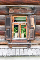 old vintage window in old wooden house in russian village