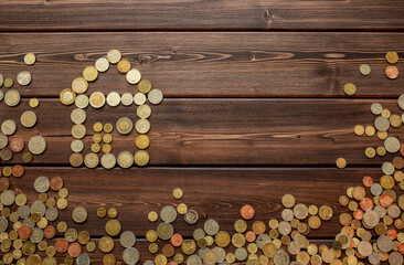 Silhouette of a house made of coins on a wooden background. The concept of mortgages, savings for...