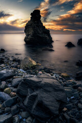 Sunset on a beach with rocks