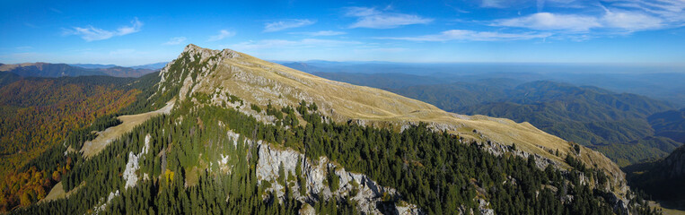 Aerial panorama of Buila Massif with its rocky crest. The mountain has sharp abysses covered with...