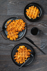 Waffle breakfast and coffee on a wooden table