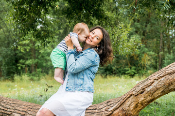 Naklejka premium Mother and little baby playing together in a park