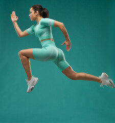 Sporty young woman running in the air