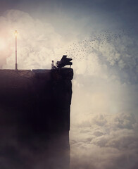 Person silhouette on the edge of a cliff sings and plays a piano song, as flock of birds flying out...