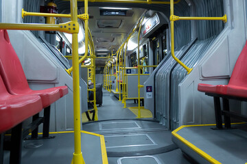 BOGOTA, COLOMBIA - A transmilenio bus inside at night with one person and travel bag. 