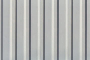 Obraz premium Texture of the wall with gray vertical siding panels in strips