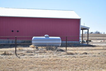 Propane Tank by a Metal Building © Steve