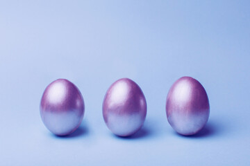 Silver easter eggs on a blue background.
