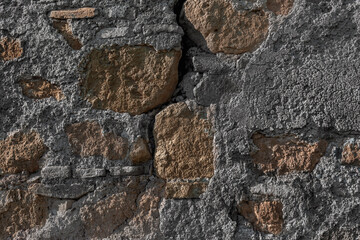 Texture of medieval crumbling stone basement wall. Large hard cobblestones of natural rocky block cement structure. Dirty broken bumpy shabby daub. Retro aged vintage messy masonry for design material
