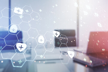 Double exposure of creative abstract medical hologram and modern desktop with laptop on background. Healthcare technolody concept