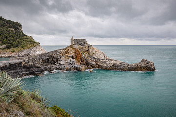 Portovenere (Porto Venere) in Liguria, Italy: beautiful aerial scenic view of the Church of St....