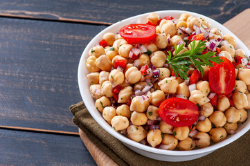 .Delicious chickpea salad with tomatoes, onions, peppers and parsley, Copy space