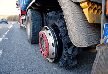 Close up of a truck with burst tyre on the motorway. Flat tire and Tire burst on the road