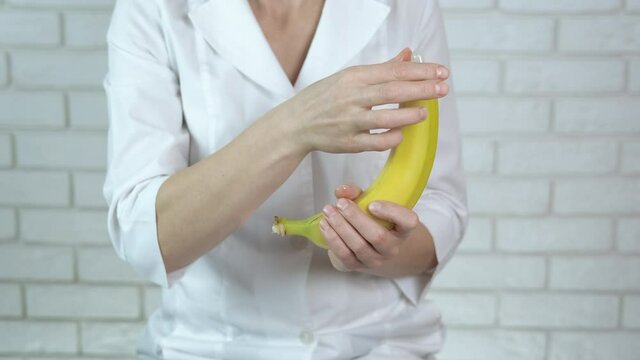 Doctor and Sex Education. Doctor with a banana and a condom.