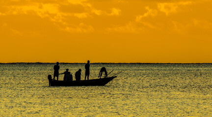 Fototapeta premium A traditional native nagalawa at sunrise. The ngalawa or ungalawa is a traditional, double-outrigger canoe of the Swahili people living in Zanzibar