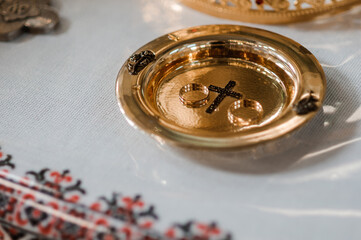 Wedding rings on a golden plate