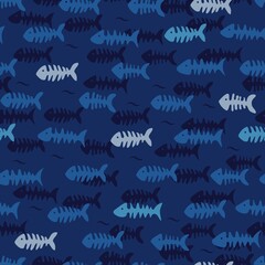Fish bones on blue background. Seamless summer pattern.