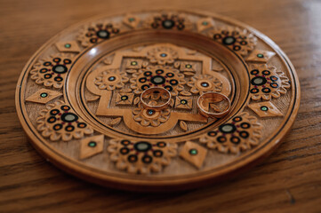 Wedding rings on a golden plate
