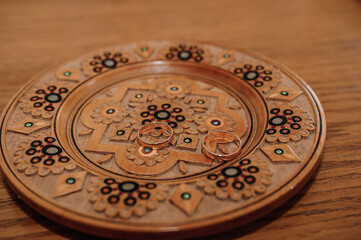 Wedding rings on a golden plate
