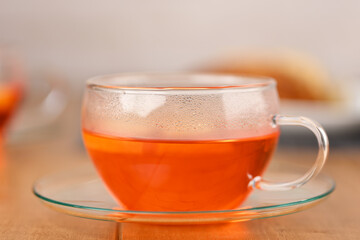 Fruit hot tea in a glass cup.