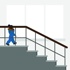 A small child in warm clothes descends the stairs against the background of a wall with a window