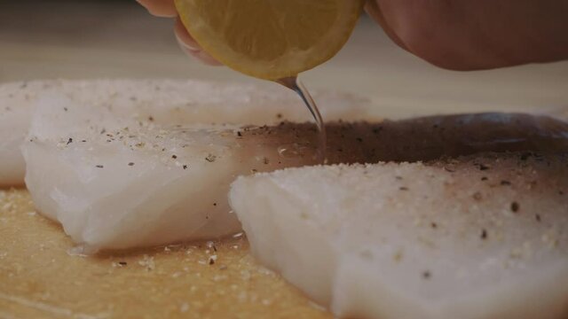 Fresh lemon over raw cod fish