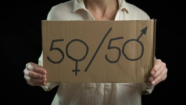 Equality concept. A woman holding a 50-50 sign.