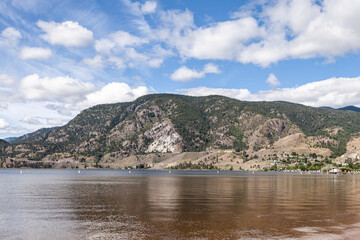 Panoramic view of summer landscape in the British Columbia with clear mountain lake background