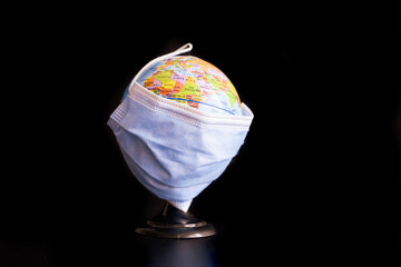 Covid mask covers around all over the world. Metaphor and allegory concept.