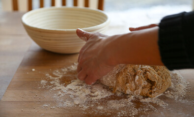Hands of woman kneading sourdough  