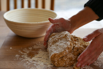 Fototapeta premium Hands of woman kneading sourdough 