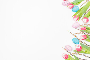 Flat lay easter composition with pink tulips and eggs on white background