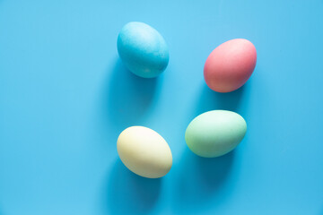 Easter eggs painted in pastel colors on blue background. Easter concept