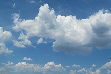 Naklejka na ściany i meble Fluffy clouds in the blue sky