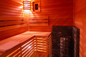 Concept of SPA treatments. Sauna without people. Relax in the hot sauna. Interior view of the sauna. Hot stone on the heater in the SPA complex.