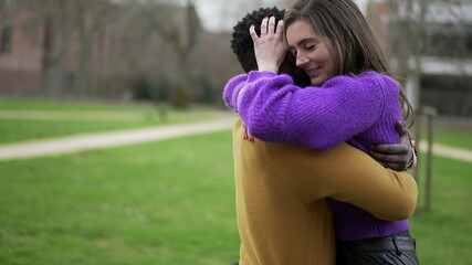 Obraz premium Interracial couple love and embrace. Black man hugs girlfriend, close-up hands back