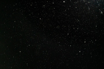 Snow against a black sky. Snow on a black background. Snow background.