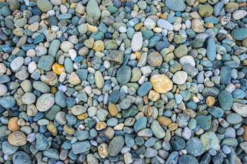 Multi-colored pebbles on the beach on the Black Sea. Pebble background. Coast. Pebble texture