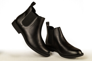 Close up of a women's black leather chelsea boots on white background. Fashion advertising shoes...